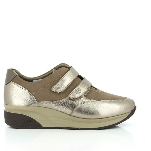 A pair of 24 Hrs 23056 Gold Sneakers showcasing a radiant gold leather upper with two Velcro straps for a secure fit. These women's sneakers are designed with a classic round toe and a comfortable 3 cm heel-platform. The leather lining and synthetic sole ensure durability and all-day comfort. Made in Spain, they reflect 24 Hrs' commitment to quality and style.