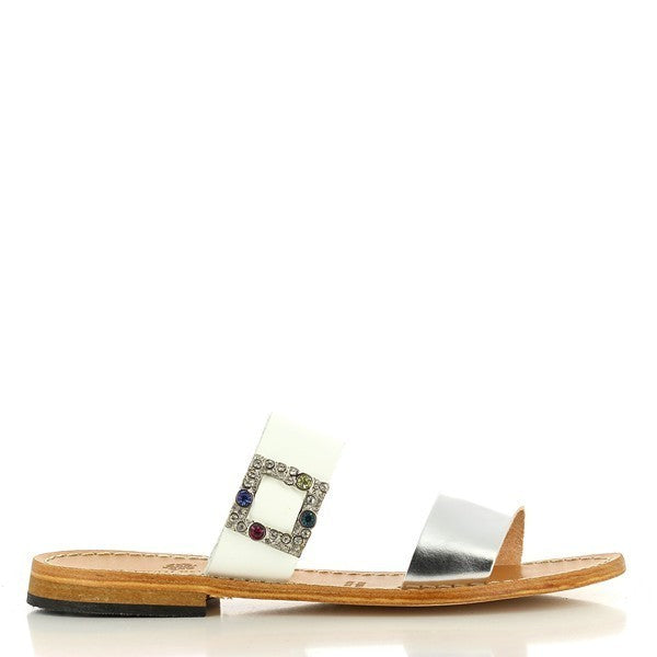 The Antichi Romani 947 Bianco White Slides are elegantly displayed against a soft, neutral backdrop, highlighting their clean and sophisticated design. The slides feature a smooth white leather upper that exudes luxury, complemented by a minimalist round toe shape for a classic look.