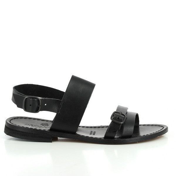 The side angle reveals the smooth, high-quality black leather upper with clean stitching, accentuating the minimalist design. The adjustable slingback strap elegantly wraps around the heel and fastens with a subtle metallic buckle. The 1cm platform provides a slight lift for comfort and style.