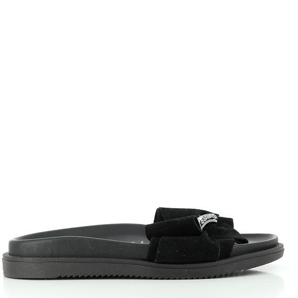 A pair of sleek Antichi Romani 960 Nero Black Slides are displayed against a minimal, light background. The sandals feature a simple yet elegant design with a smooth black leather upper that wraps over the foot, leading to a rounded toe. The craftsmanship is highlighted by the visible stitching along the edges, showcasing the brand's attention to detail. The leather lining and sole add a polished finish, while the subtle 2cm heel-platform offers a hint of lift.