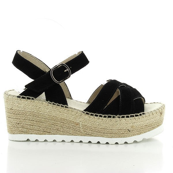 The image features the Calzanor 2039 Black Slingback Espadrilles, highlighting their elegant design and craftsmanship. The sleek black leather upper shines subtly, showcasing the shoe's refined aesthetic. The 7 cm platform heel is wrapped in natural jute, adding a classic espadrille touch, while the round toe shape offers a timeless appeal. An ankle buckle fastening enhances the fit and adds a stylish detail.