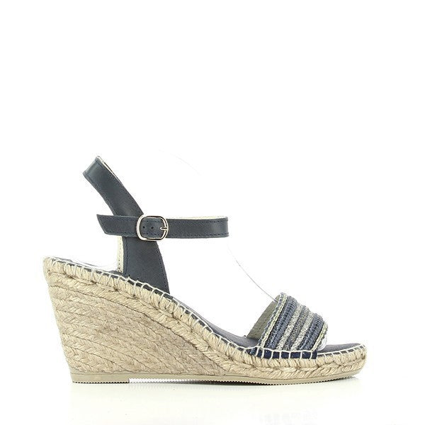 A pair of Calzanor 2057 Navy Slingback Espadrilles is elegantly presented against a soft, neutral backdrop. The sophisticated navy leather upper showcases a sleek design that seamlessly blends style with comfort. The slingback strap adds an element of elegance, while the rounded toe ensures a comfortable fit. The 9 cm jute platform sole, meticulously hand-stitched, highlights the eco-friendly materials and expert craftsmanship.