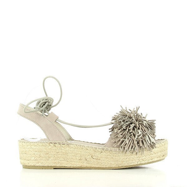 The Calzanor 2134 Taupe Slingback Espadrilles are displayed against a light, neutral background, highlighting their elegant design. The espadrilles feature a taupe leather upper with a smooth finish, complemented by delicate lace-up details around the ankle for a secure and stylish fit. The jute platform sole, slightly raised at 4.5 cm, gives a natural, earthy tone, emphasizing the handcrafted quality. The round toe shape and the slingback strap complete the sophisticated look.