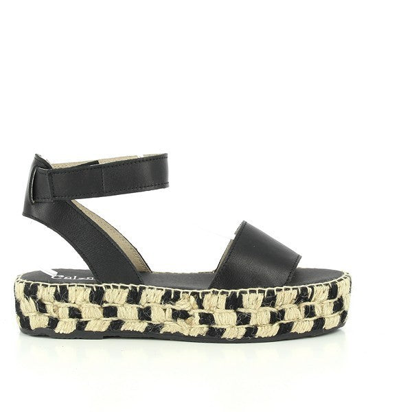 A pair of Calzanor 2233 Black Slingback Espadrilles displayed against a simple, light-colored background. The shoes feature a sleek black leather upper with a stylish slingback strap and a round toe design, offering a sophisticated and versatile look. The jute-wrapped 4cm platform heel adds an earthy texture, emphasizing the handcrafted quality. The overall aesthetic is elegant and modern, making these espadrilles perfect for both casual and dressy summer outfits.