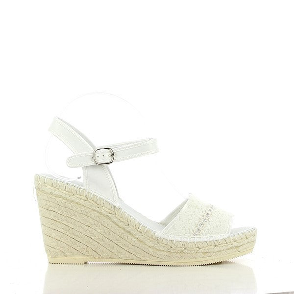The photo features the Calzanor 743 White Slingback Wedge Espadrilles displayed against a soft, neutral background. The espadrilles showcase a sleek, minimalist design with a smooth white leather upper that glistens subtly in the light. The rounded toe offers a classic touch, while the elegant slingback strap, adorned with a delicate buckle, enhances both style and functionality. The wedge heel stands at 10 cm, elegantly elevated yet stable, perfect for all-day wear.