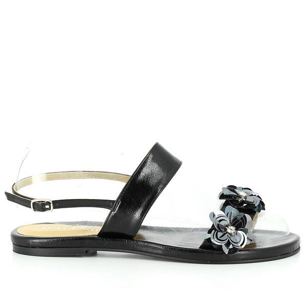 A pair of Dalessi Dakota Black Slingback Sandals elegantly displayed against a light background. The sandals feature a synthetic black upper with delicate floral accents along the strap, adding a feminine touch. The round-toe design and a modest 1.5cm platform heel offer a blend of style and comfort. The soft leather lining and sleek slingback strap provide a secure and comfortable fit. The sandals' synthetic sole is visible, highlighting their sturdy construction.