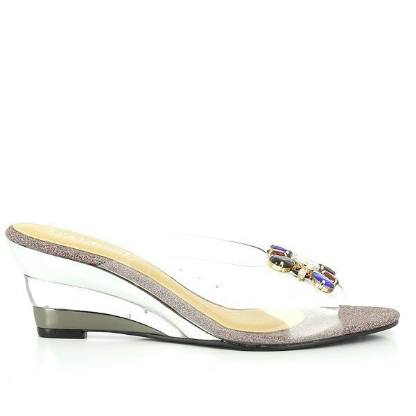 A clean side profile highlighting the transparent upper and heel, with the rich purple tone adding a vibrant touch. The decorative jeweled buckle glistens as a statement feature.