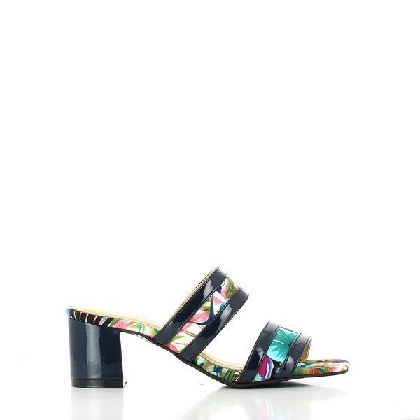 A side view of the Dalessi Dcuba Black Slides, showcasing the two-stripe leather straps adorned with blue tropical motifs and the bold black square heel, exuding modern elegance.