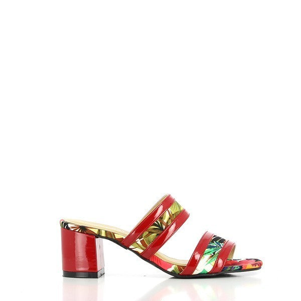 A side view of the Dalessi Dcuba Red Flowers Slides, featuring two leather straps with vibrant tropical flower motifs and a bold red square heel for a stylish pop of color.