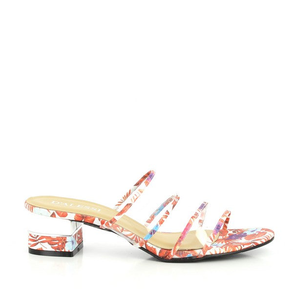 The slide's profile captures the four thin red straps adorned with subtle tropical motifs and the elegant transparent heel, emphasizing its modern, stylish design.
