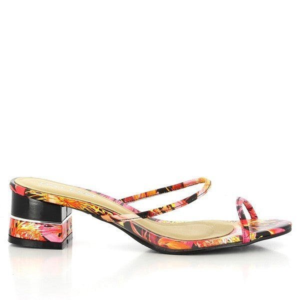 The Dalessi Dejavu Red Slides are displayed on a light background, highlighting their vibrant red color and chic design. Each slide features two thin leather straps with delicate tropical motifs, adding an exotic, summery feel. The 5 cm platform heel provides a slight lift while maintaining a comfortable, casual look. The round toe shape offers a relaxed fit, and the synthetic sole ensures durability and grip.