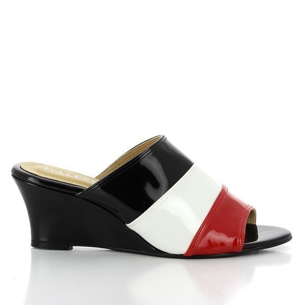 The Dalessi Deora Black Slides showcase a chic and contemporary design, featuring a wide strap in black, white, and red hues that adds a bold yet elegant touch. The sleek synthetic upper contrasts beautifully with the soft leather lining, providing a comfortable and breathable fit. A wedge heel, standing at 6.5 cm, adds a subtle lift to the slides while maintaining a comfortable, all-day wearability. The round toe shape completes the design, offering a relaxed and stylish look.