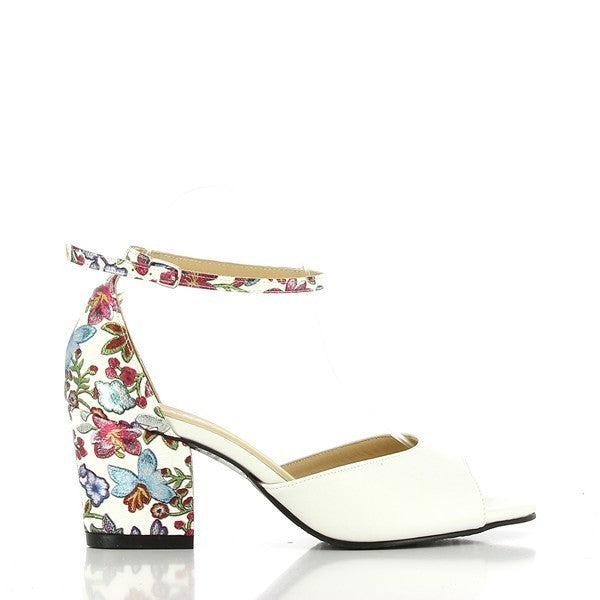 The Dalessi Deuce White Floral Slingback Sandals feature a luxurious white leather upper adorned with intricate white floral motifs on the heel. The sandals showcase a stylish peep toe design, offering both breathability and elegance. The 7 cm heel-platform provides a flattering lift, while the adjustable slingback strap ensures a secure, personalized fit. The round toe shape adds comfort, making these sandals a perfect balance of style and practicality.