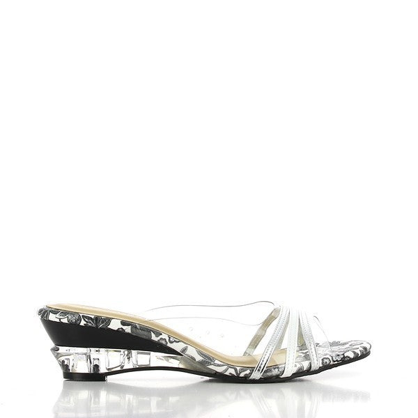 A side profile of the Dalessi Diverge White & Silver Slides showcases its elegant design, featuring three sleek white and silver leather straps atop a transparent upper and heel. The 5.5 cm platform heel adds subtle elevation, while the round toe shape offers a timeless silhouette.