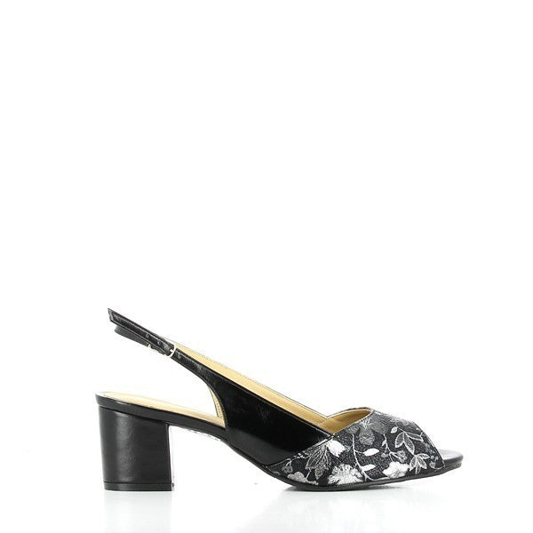 A profile view of the Dalessi Duprey Black & Silver Slingback Sandals, showcasing the sleek leather upper and silver floral accents. The classic slingback design is highlighted, with the rounded toe adding a touch of elegance.