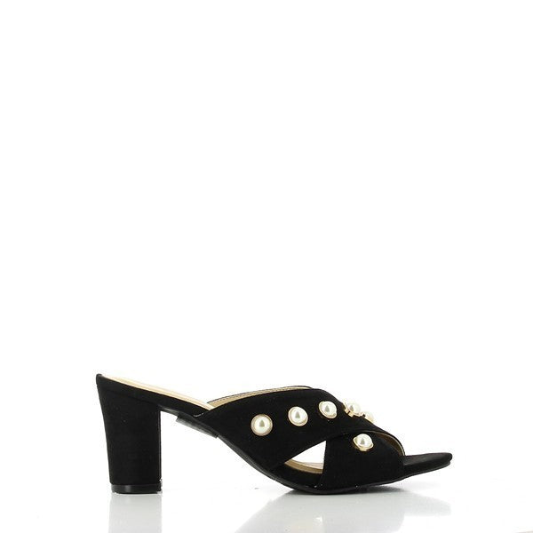 The side view of the Dalessi Pearl Black Slides showcases the smooth leather upper, with a round toe design and a 7.5 cm heel that gives it an elegant lift.