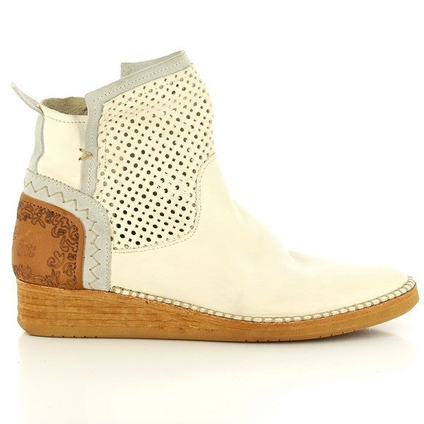 The side profile of the Felmini A044 White Ankle Boots showcases their sleek and elegant design, featuring a smooth white leather upper with die-cut holes for added texture. The round toe and subtle 3 cm heel provide a flattering silhouette, perfect for any occasion.