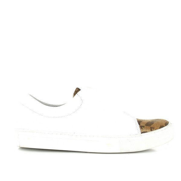 A close-up view of the side of the sneaker, showcasing its smooth white leather upper and distinct jaguar print accent along the side. The rounded toe and clean lines reflect the sleek design, highlighting the craftsmanship.