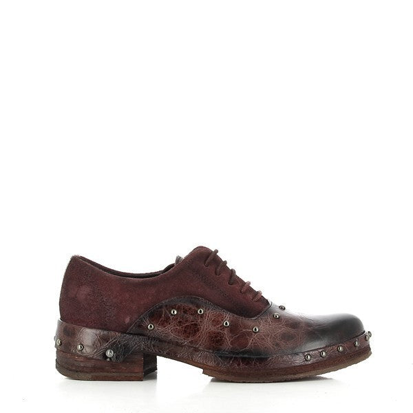 A clear image of the Felmini B245 shoe's burgundy leather side, showcasing its elegant combination of smooth and textured leather, decorative studs, and classic Oxford lace-up design.
