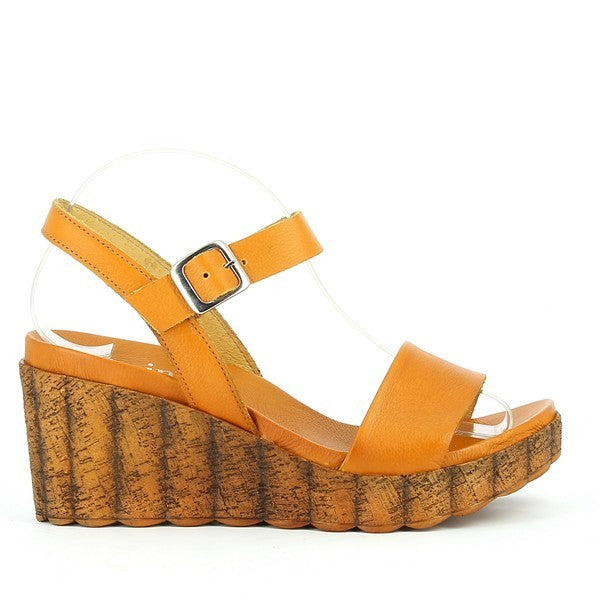 A sleek profile of the Felmini C295 Light Brown Slingback Wedge Sandal, showcasing the smooth leather upper, adjustable ankle strap with a metallic buckle, and cork-textured wedge sole.