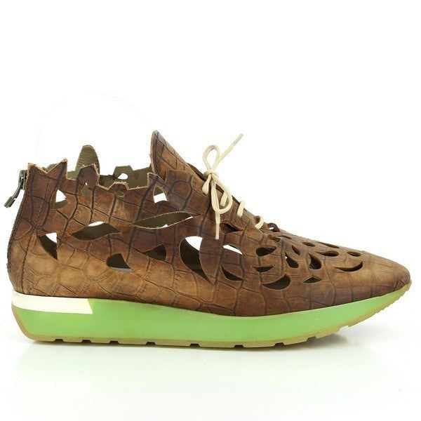 The sleek, brown leather sneaker showcases its minimalist design with a laser-cut pattern along the sides, giving it a modern, textured look. The pointed toe adds a sophisticated touch, and the clean lines highlight the shoe’s craftsmanship.