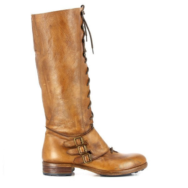 A full side profile of the boot, showcasing its elegant lace-up design and three decorative straps across the ankle. The sleek, tan leather upper shines subtly, emphasizing the clean lines and craftsmanship of the boot.