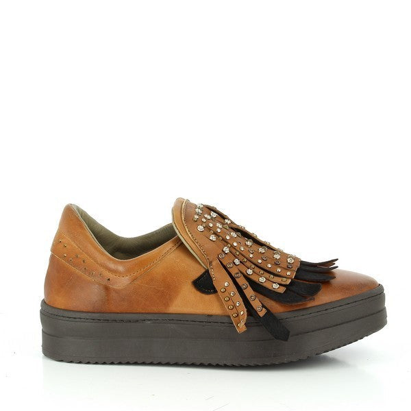 A close-up of the Forte W167025 Tan Sneakers, showcasing the smooth leather upper in a warm tan color, with the intricate black fringe detailing along the side, offering a stylish contrast. The round toe and clean lines highlight the shoe’s timeless design.