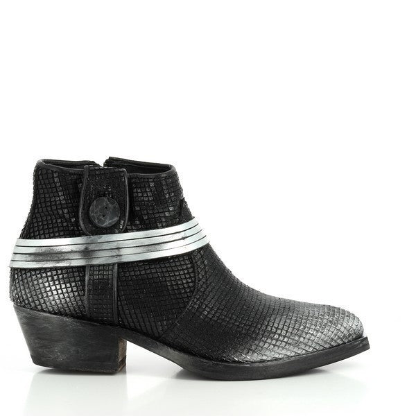 A sleek profile of the black leather ankle boot, highlighting its smooth finish and decorative silver strap across the upper, offering a sophisticated touch.