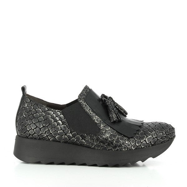 A sleek black slip-on sneaker with a textured snake print leather upper, a subtle 3cm platform sole, and stylish fringe detail on the front.