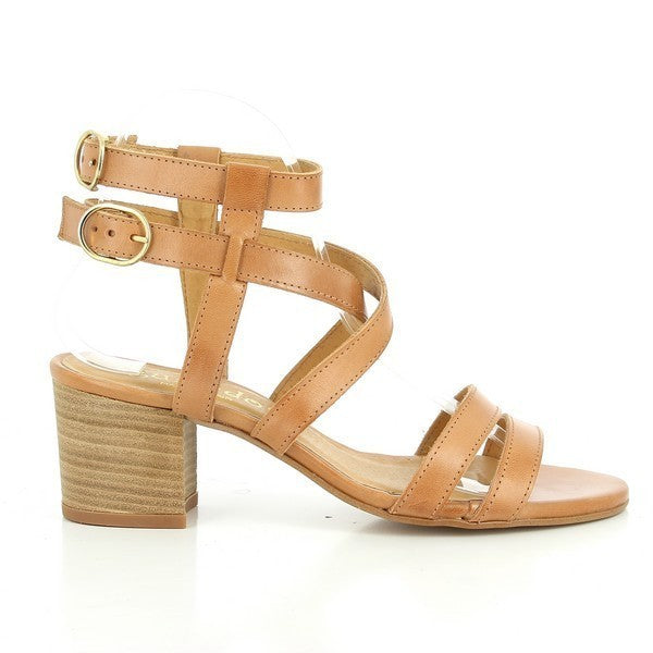 The side profile of the tan slingback sandal shows the sleek leather upper, rounded toe, and the delicate ankle straps with adjustable buckles.