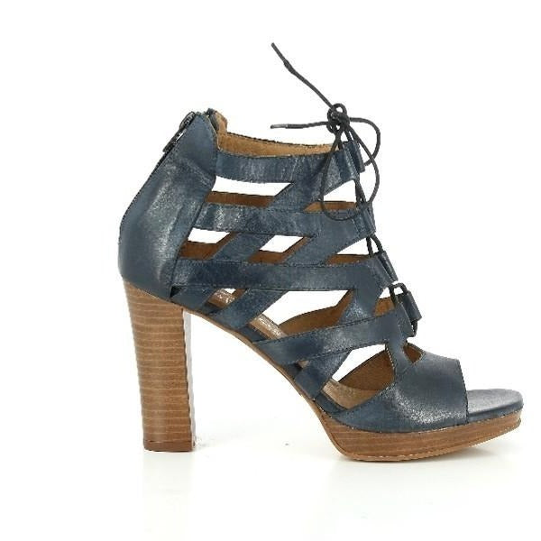 The photo shows the sleek profile of the navy leather sandal, with a stylish lace-up design that runs from the toe to the ankle. The round toe adds a classic touch to the contemporary look.