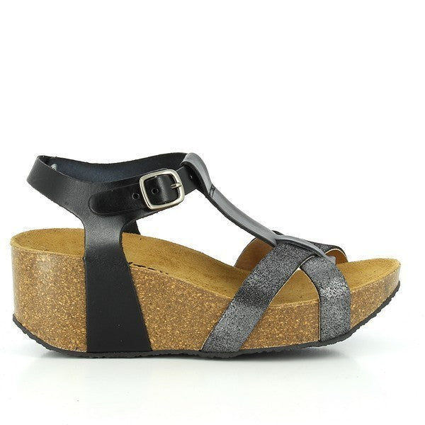 A close-up image showcasing the side profile of Plakton's 273015 Black Wedges. The sleek black leather upper contrasts elegantly with the natural cork sole. The unique cross-band design and adjustable buckle strap are prominently featured, highlighting both style and functionality.