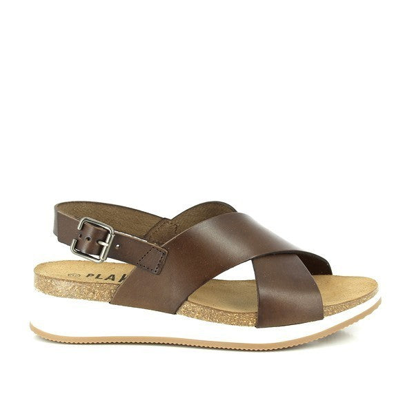 Capture the side profile to highlight the cross-strap design and the 4cm cork wedge heel. This angle emphasizes the stylish yet comfortable silhouette of the sandals.