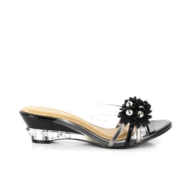 A clear side view of the Dalessi Dupont Black Slides, showcasing the sleek leather upper, transparent floral detailing, and round toe shape. The transparent heel adds a modern touch, complementing the elegant design.