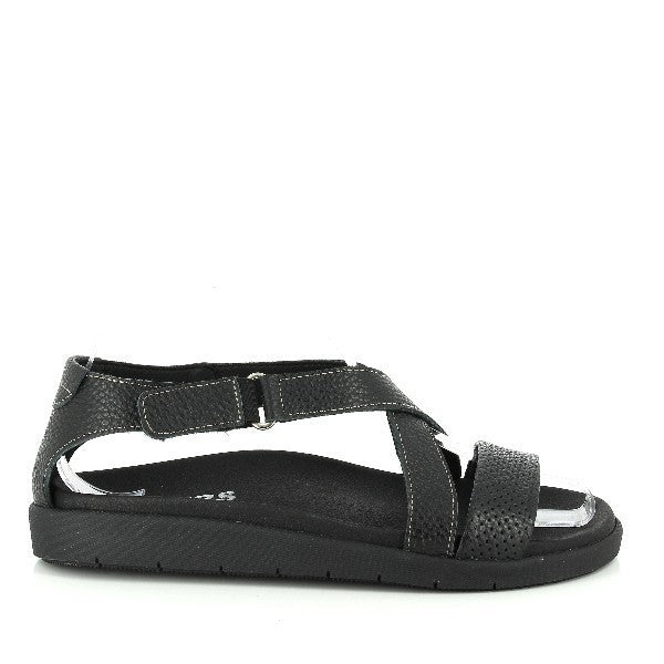 The 24 Hrs 22920 Black Slingback Sandals are displayed from the side, showcasing the sleek black leather upper and elegant design. The slingback strap is prominently featured, highlighting its stylish and practical look. The 2 cm heel-platform height adds a subtle lift.