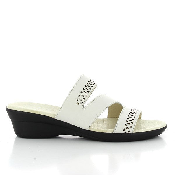 A pair of 24 Hrs 23265 White Slides for women is showcased on a neutral background. The slides feature a sleek white leather upper with three front straps, a round toe, and a 4 cm heel. The soft leather lining and durable synthetic sole highlight the comfort and craftsmanship of these stylish slides, made in Spain.