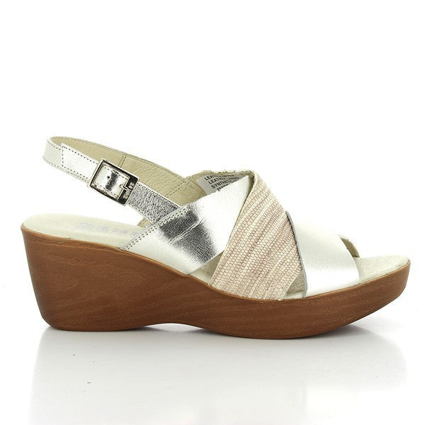 The 24 Hrs 23301 Silver & Beige Slingback Wedges are elegantly showcased against a neutral background. The sandals feature a sleek silver and beige leather upper with a stylish slingback design and an adjustable buckle for a secure fit. The 6 cm heel-platform provides a sophisticated lift, while the classic round toe shape adds timeless appeal. The craftsmanship is evident in the soft leather lining and durable synthetic sole, highlighting the expert quality of these Spanish-made wedges.