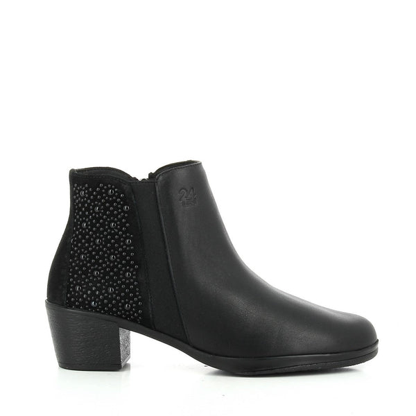 A pair of 24HRS 24194 Black Ankle Boots displayed from a slightly angled perspective, highlighting the sleek black leather upper and the smooth, polished finish. The image shows the 3 cm heel, rounded toe, and the subtle inner side zipper, emphasizing the boot’s blend of classic style and practical design.