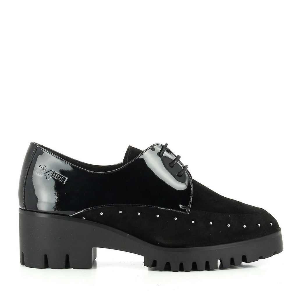 A pair of 24HRS 24262 Black Lace-Up Shoes captured from an angled side view, showcasing the elegant black leather upper and the classic lace-up design. The image highlights the 5 cm heel-platform and the round toe shape, with a focus on the sleek leather finish and the sturdy synthetic sole, embodying both sophistication and comfort.