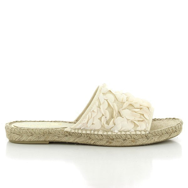 The photo features a pair of Calzanor 2012 White Slide Espadrilles, elegantly displayed against a light backdrop. The upper is made of pristine white leather, giving the shoes a fresh and clean appearance. The rounded toe design complements the casual yet chic style, making them perfect for summer outings. The espadrilles are showcased with a hand-stitched jute sole that highlights their artisanal craftsmanship, providing both durability and eco-friendliness. 