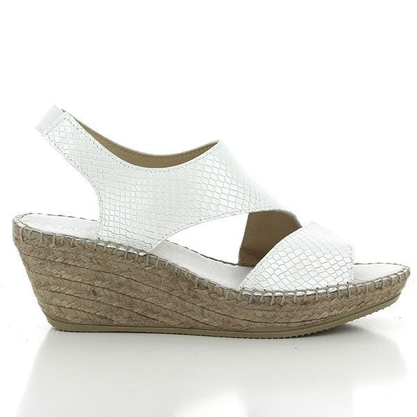 The image shows the Calzanor 2042 White Slingback Espadrilles resting on a light, textured background. The sleek white leather upper creates a polished, clean look, with a slingback strap elegantly wrapping around the heel. The soft leather lining peeks out from the shoe's interior, adding a touch of luxury. The natural jute sole contrasts beautifully with the bright white upper, highlighting the craftsmanship of the espadrilles.