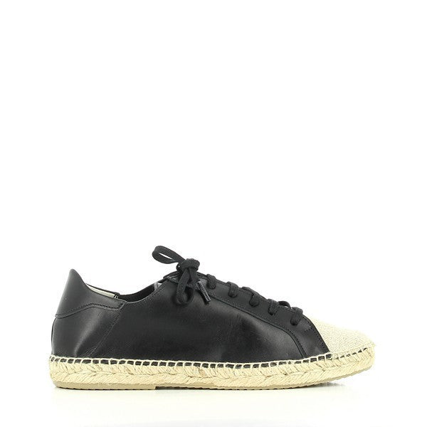 The Calzanor 2086 Black Lace-Up Espadrilles are beautifully displayed on a smooth, neutral background that highlights their sophisticated design. The upper features rich black leather, showcasing a sleek and polished finish, while the lace-up detailing adds a touch of modernity and adjustability. The round toe shape is inviting and classic, and the 2 cm synthetic sole is subtly visible, emphasizing comfort and practicality. 