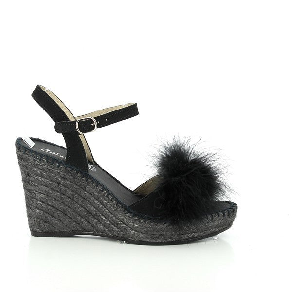 A pair of Calzanor 2213 Marabu Black Slingback Espadrilles is elegantly displayed on a clean, light background. The black leather upper has a smooth, polished look, complemented by a stylish slingback strap for a secure fit. The round toe and 10cm jute-wrapped platform heel showcase Calzanor's signature craftsmanship, merging timeless design with modern lift. The natural jute sole provides texture and a hint of rustic charm, enhancing the sophisticated black tone. 