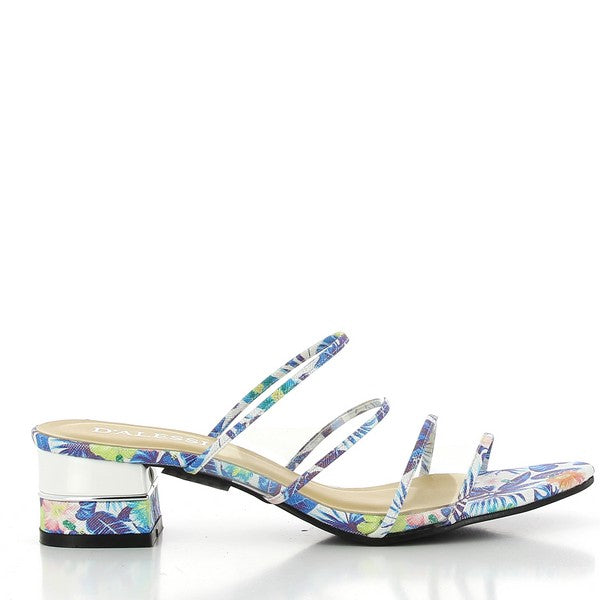 A side view of the Dalessi Decaf Pewter Sandals, showcasing the four thin straps, transparent heel, and tropical motifs that add a stylish touch to the design.

