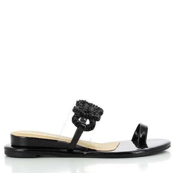 A close-up of the Dalessi Decoy Black Sandals from the side, showcasing the sleek black synthetic upper with a crochet-textured strap and a slim, comfortable 1cm platform.
