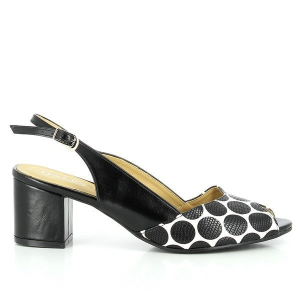 A profile view of the Dalessi Duprey Black & White Slingback Sandals, highlighting the sleek leather upper with black dots and the classic slingback design. The round toe shape provides a smooth, elegant silhouette.

