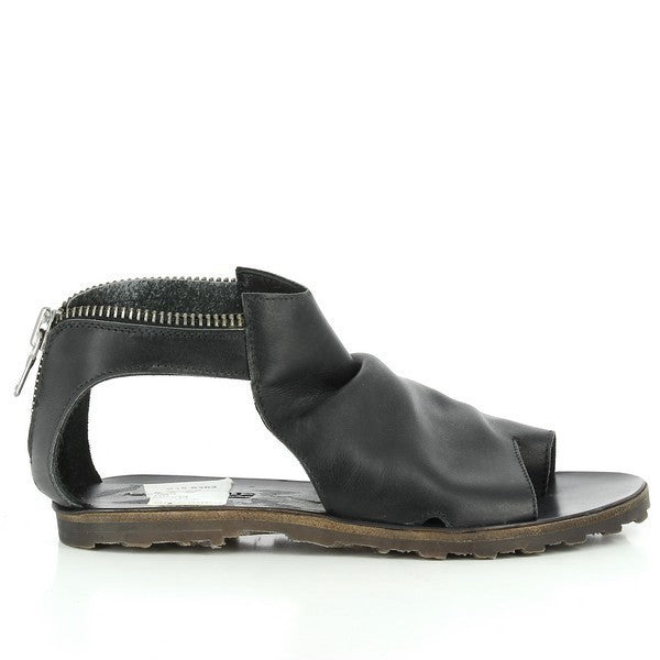 A sleek black sandal showcasing its open-toe design, wrinkled leather upper, and flat synthetic sole, with visible side cut-outs for a modern touch.