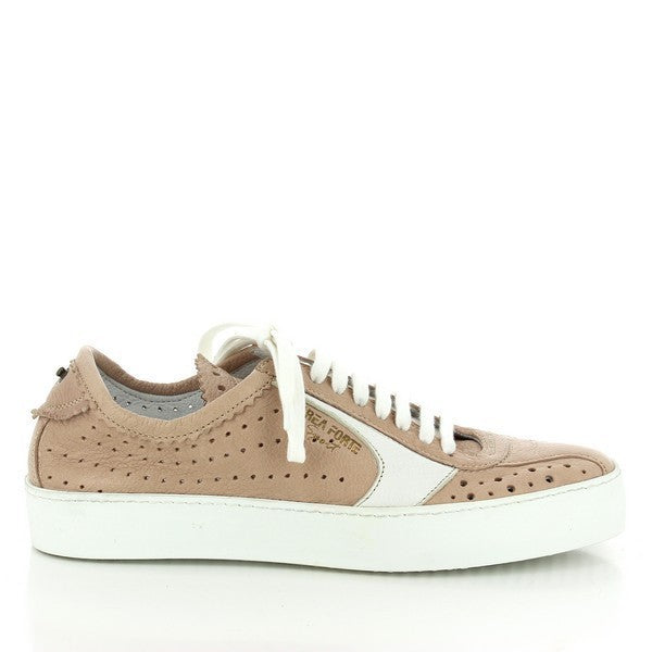 The side of the sneaker displays the sleek nude leather upper, with delicate perforations and a clean white line accent that runs along the side for a modern touch.