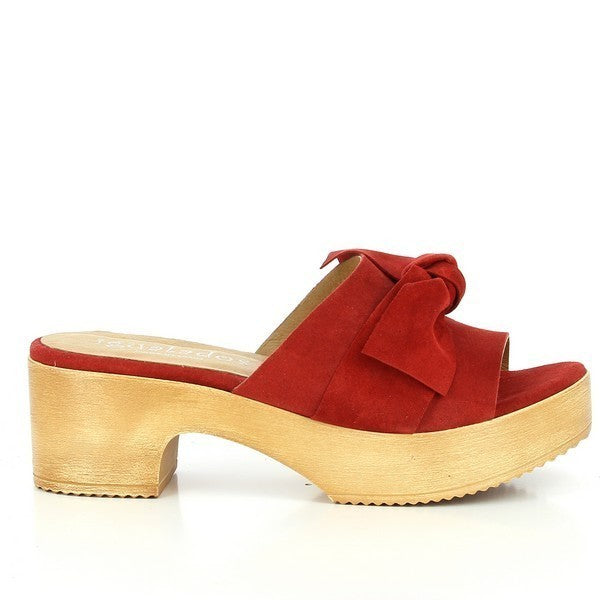 A sleek red leather slide with an open toe and a charming decorative bow on the front. The 5cm heel-platform provides a subtle yet stylish lift.