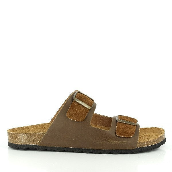 The image showcases Plakton's 100010 Tan Men's Sandals, set against a backdrop of warm, earthy tones. The sandals, crafted with a leather upper and cork sole, exude timeless sophistication and eco-friendly elegance. Two sturdy buckles offer a customizable fit, while the rounded toe shape ensures natural comfort. 